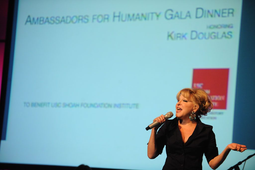 A woman is speaking on stage at an event.