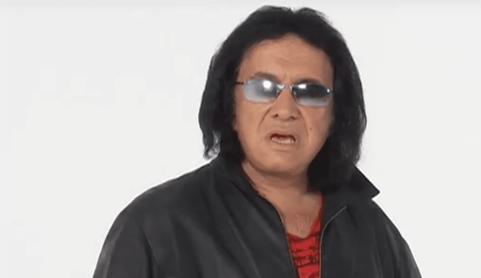 A man with long hair wearing sunglasses and a leather jacket.
