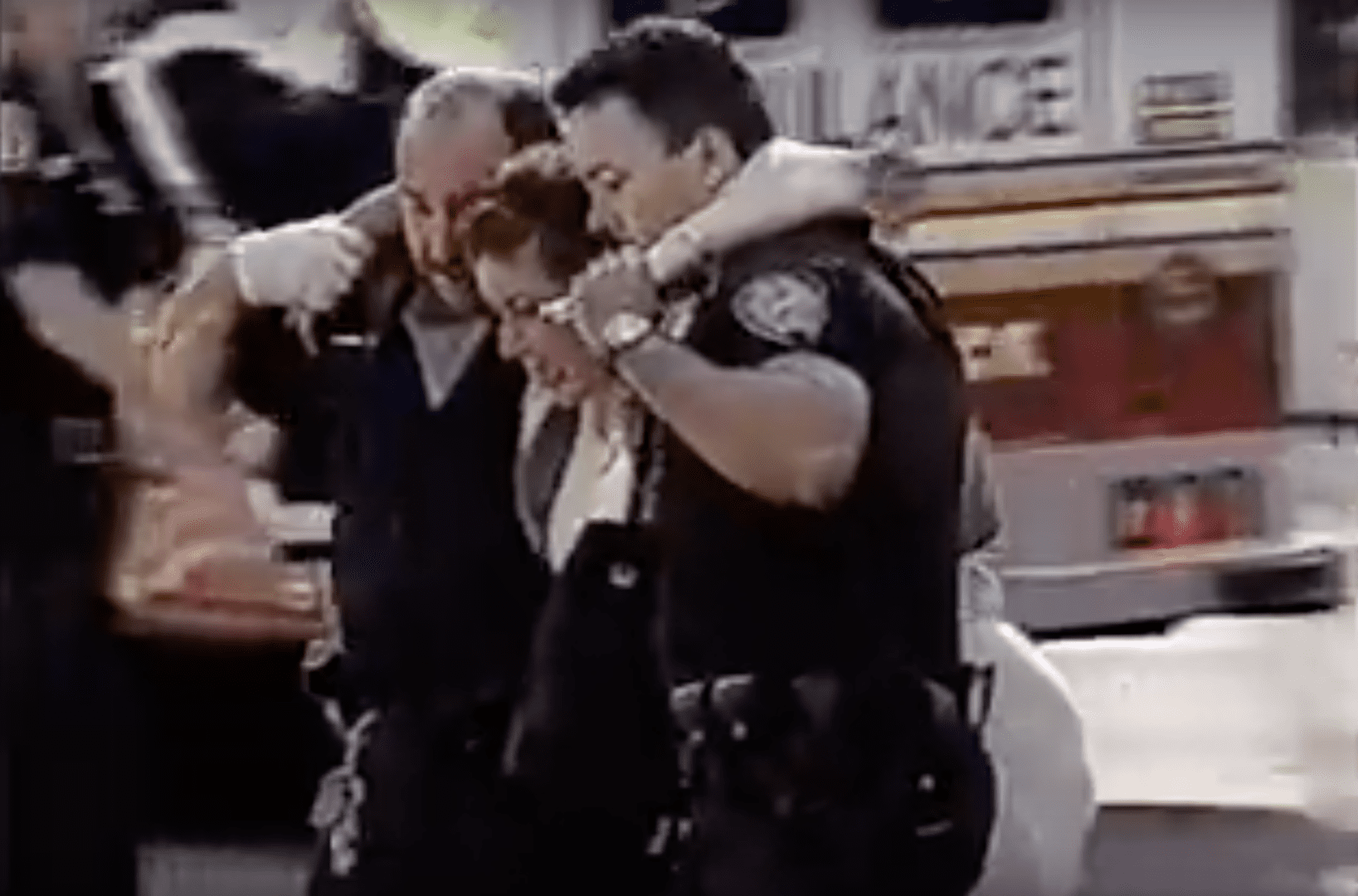 A couple of police officers are hugging each other