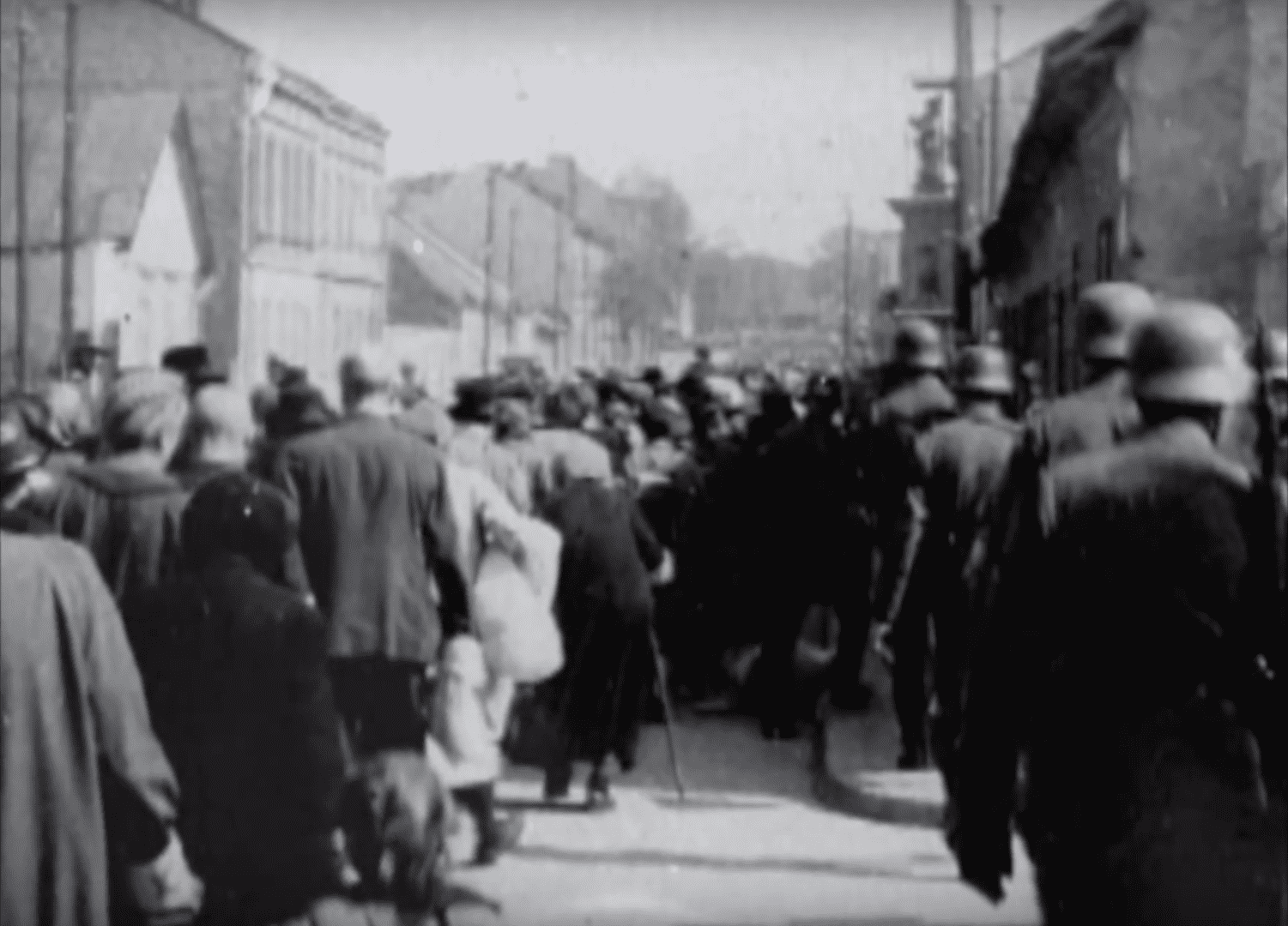 A black and white photo of people walking down the street