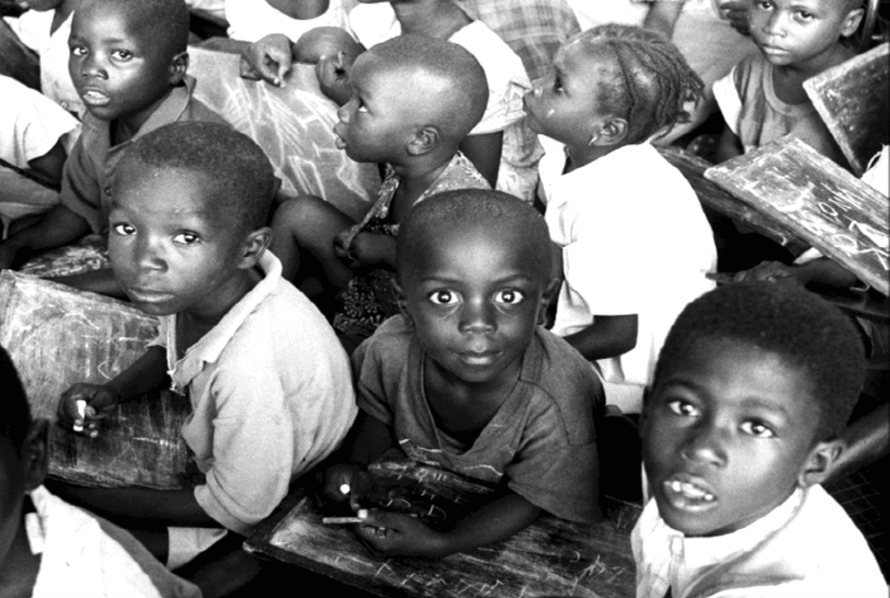 A group of children sitting in a room.